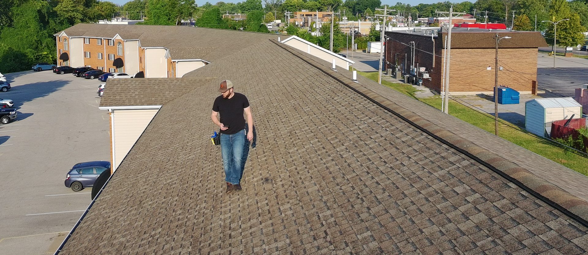 Vanguard adjuster walking a shingle roof during a storm damage inspection