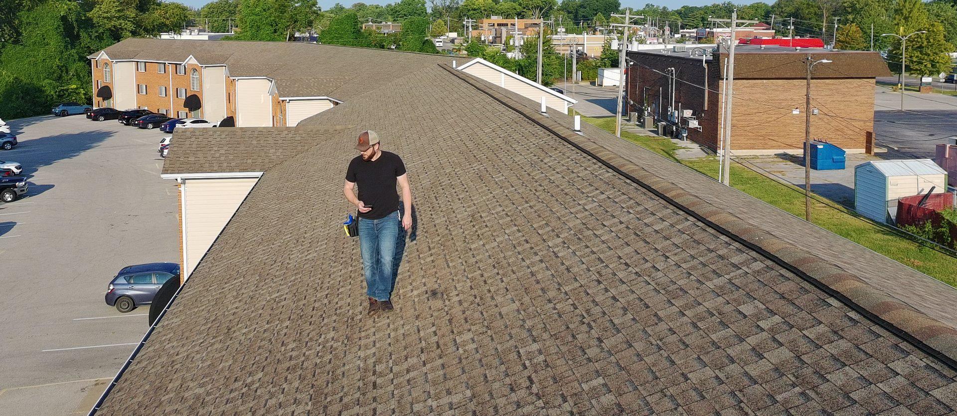 Vanguard adjuster walking a shingle roof during a storm damage inspection